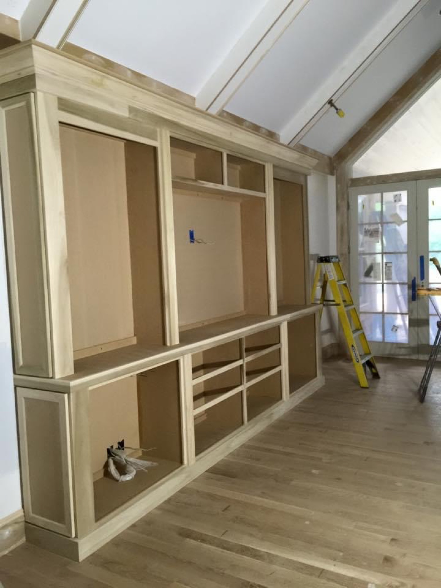 Built-in entertainment wall with stone fireplace