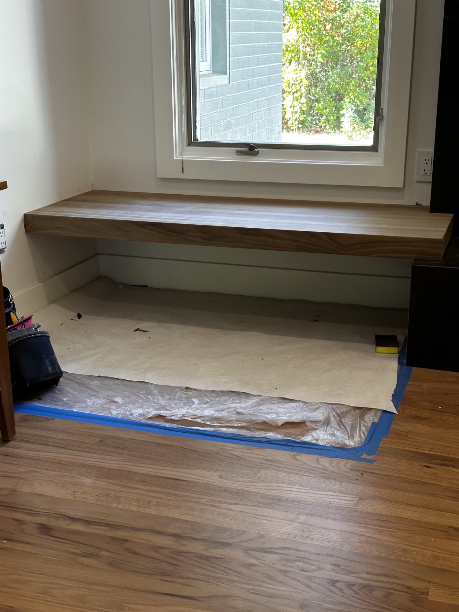 Cantilevered walnut window seat