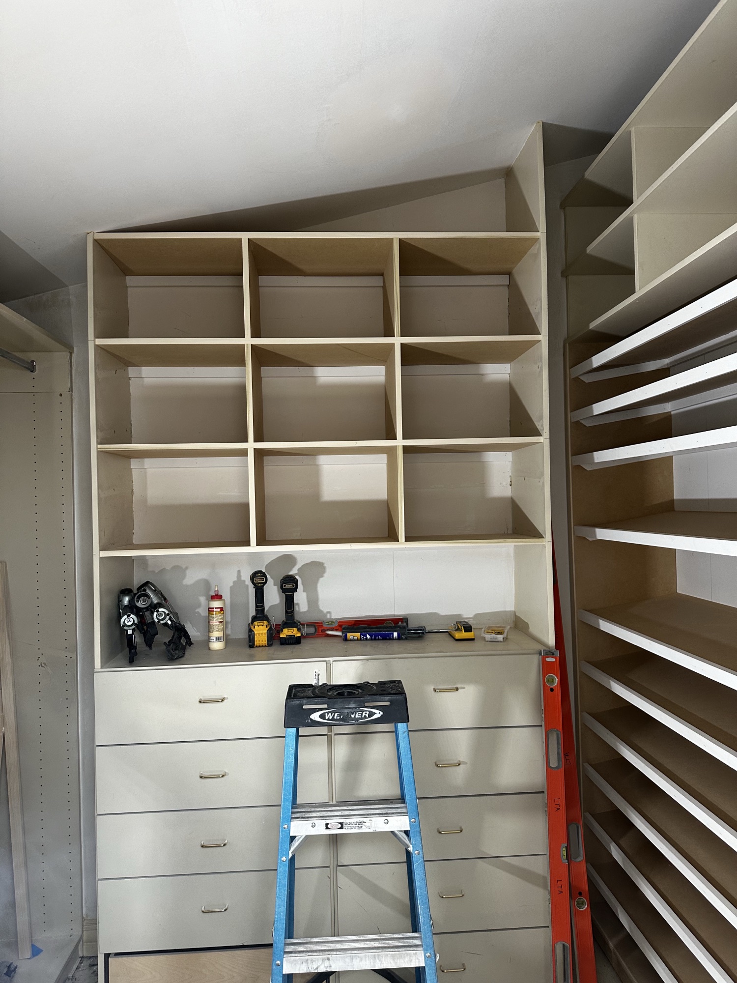Finished attic walk-in closet with drawers