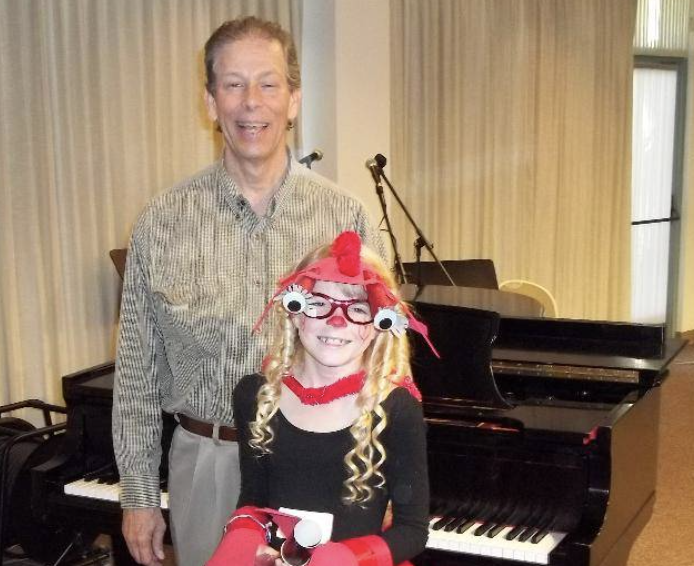 Beginner piano student learning basic techniques with instructor